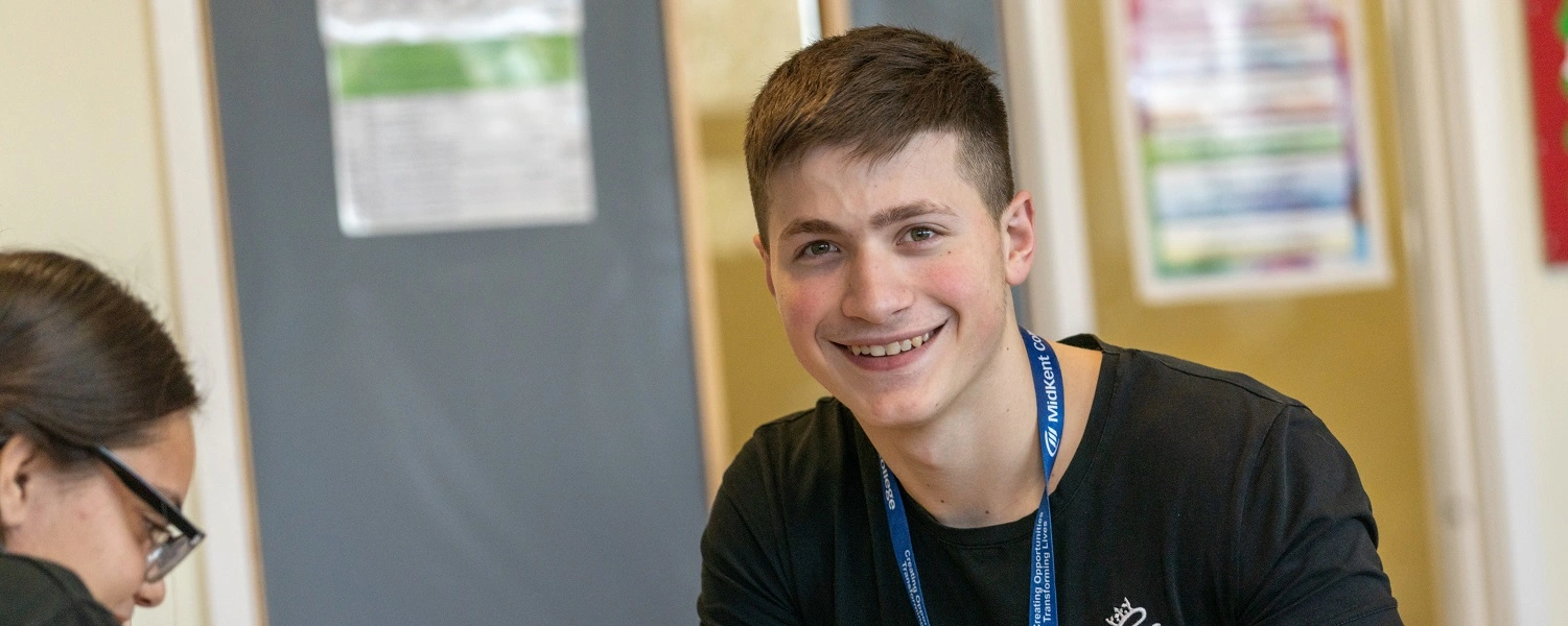 Student smiles at the camera